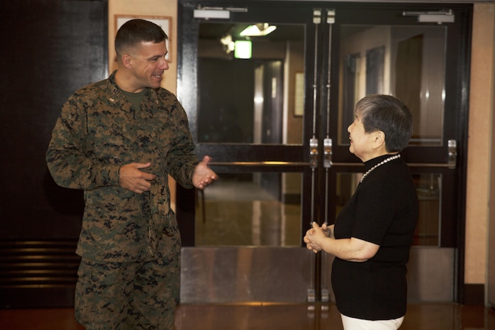 U.S. Marine Corps Lt. Col. Scott Stahl, director of contracting for Marine Corps Installaion Pacific, congratulates Hitomi Yamaguchi, a logistics-contractor specialist, on her retirement ceremony at Marine Corps Air Station Iwakuni, Japan, Dec. 16, 2016. Yamaguchi started working on the air station in 1974 and held four jobs during her 42 years of service as a stock control clerk, voucher examiner, and an administrator specialist.  However, she spent most of her time as a logistics-contractor specialist. (U.S. Marine Corps photo by Lance Cpl. Gabriela Garcia-Herrera)