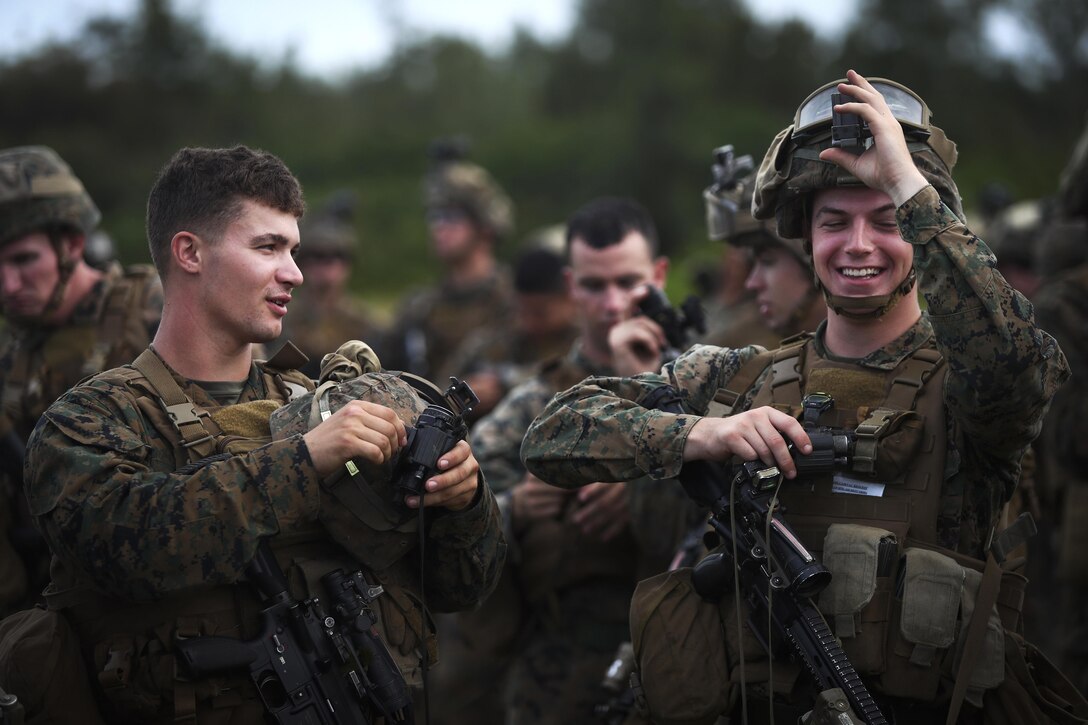 Marines prepare their gear before participating in a simulation of Operation Gothic Serpent, a 1993 operation in Somalia, at Westfield landing zone, Marine Corps Base Hawaii, Dec. 10, 2016. The Marines are assigned to Alpha Company, 1st Battalion, 3rd Marine Regiment. U.S. special operations forces conducted the actual military operation in Africa, with the primary mission of capturing faction leader Mohamed Farrah Aidid. Marine Corps photo by Cpl. Aaron S. Patterson