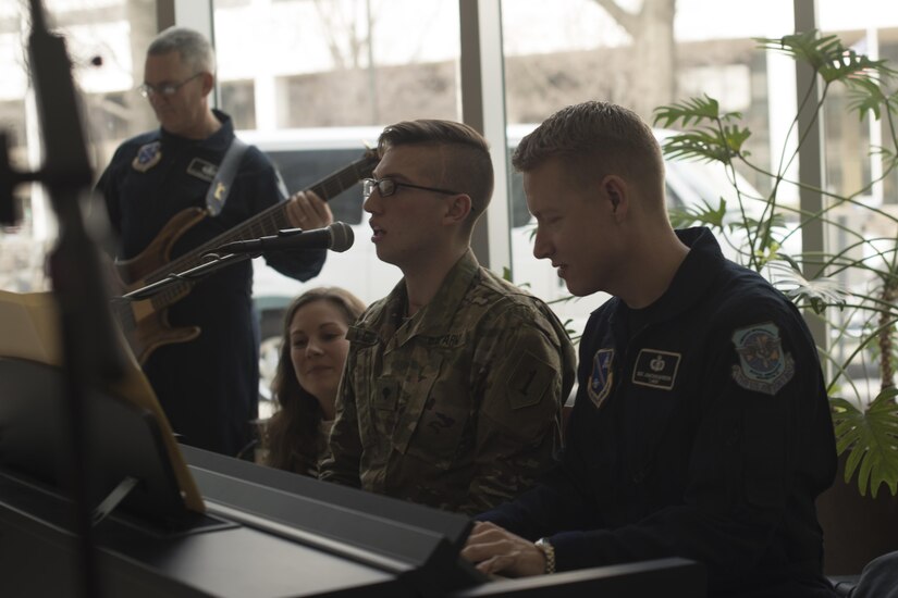 U.S. Army Specialist Tyler McGibbon, National Intrepid Center of Excellence patient, and U.S. Air Force Master Sgt. Jonathon McPherson, U.S Air Force Bann Max Impact keyboard player, perform “The Messenger” by Linkin Park at NICoE Creative Arts Café at Walter Reed National Military Medical Center in Bethesda, Md., Dec. 13, 2016. NCAC is performance platform for NICoE patients and staff to share creativity though creative arts once a month. NCAC began as a collaboration between the U.S. Air Force Band and NICoE music therapy program October 2016.  (U.S. Air Force photo by Airman 1st Class Rustie Kramer)