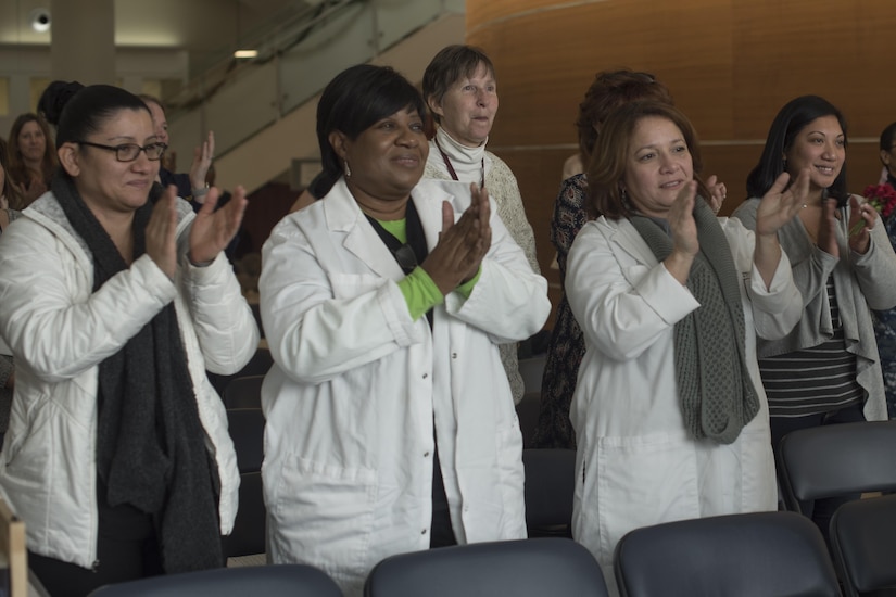 Audience members of the National Intrepid Center for Excellence Creative Arts Café give applause at the end of a performance at Walter Reed National Military Medical Center in Bethesda, Md., Dec. 13, 2016.  NCAC is performance platform for NICoE patients and staff to share creativity though creative arts once a month. (U.S. Air Force photo by Airman 1st Class Rustie Kramer)