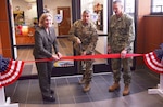 DLA Distribution commanding general Army Brig. Gen. John S. Laskodi, DLA Distribution Norfolk, Va., commander Navy Capt. Harry Thetford, and deputy commander Denise Cordeiro cut the ribbon on newly renovated office space during a ribbon cutting ceremony on Nov. 28.