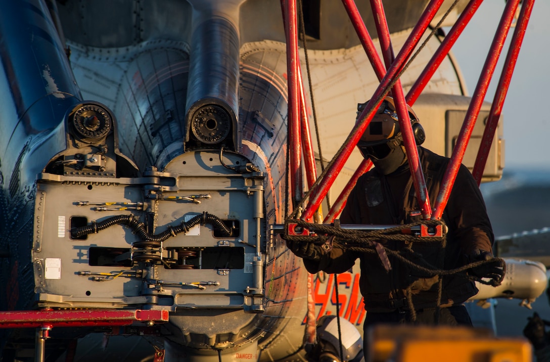 Navy Petty Officer 3rd Class Bryan McLeod removes crutch gear from an MH-60R Seahawk helicopter on the flight deck of the aircraft carrier USS Dwight D. Eisenhower in the Mediterranean Sea, Dec. 11, 2016. Navy photo by Petty Officer 3rd Class Nathan T. Beard