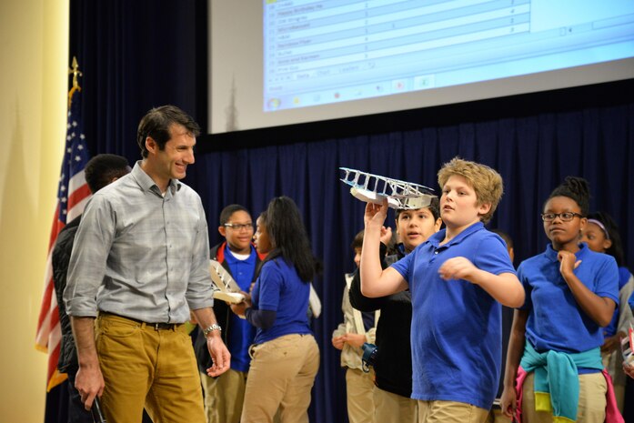 Eric Silberg (left), activity creator and aerospace engineer in Naval Surface Warfare Center, Carderock Division’s Sea-
Based Aviation and Aeromechanics Branch (Code 882), looks on as Alex Cromwell, a sixth-grader from Baltimore’s Mount Washington School, launches his team’s seaplane during the Seaplane Challenge STEM activity Nov. 28, 2016, in West Bethesda, Md. (U.S. Navy photo by Daniel Daglis/Released)