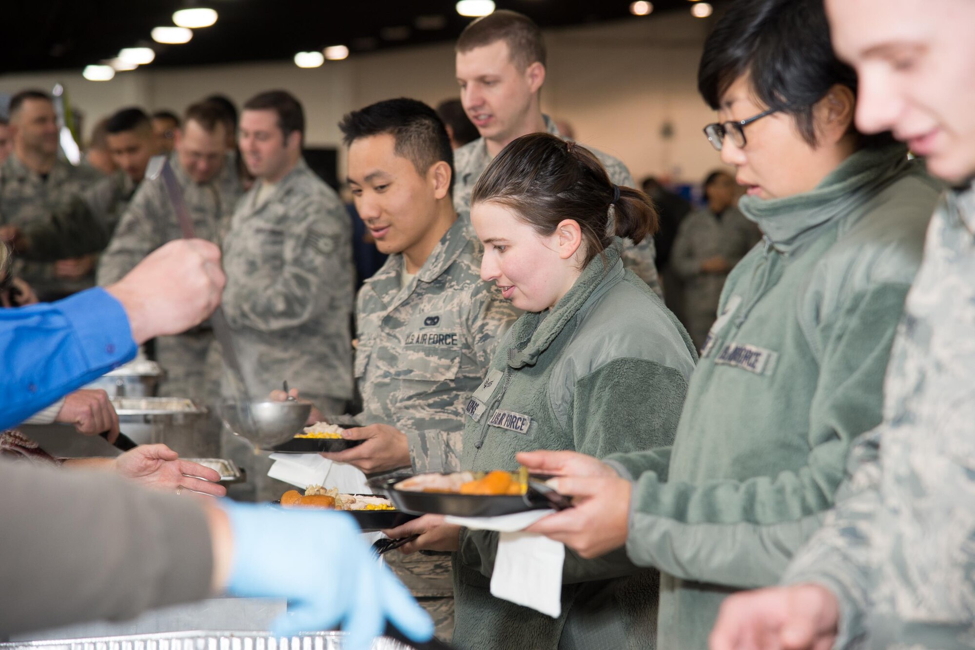 Team Dover Airmen going through the serving line at the 13th annual Feed the Troops lunch Dec. 16, 2016, on Dover Air Force Base, Del. The annual event is coordinated by Retired Air Force Reserve Master Sgt. Robert Reece and local community volunteers as a way to thank troops for their military service. (U.S. Air Force photo by Mauricio Campino)