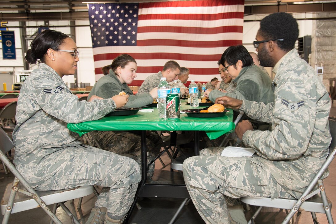 Team Dover Airmen enjoy a meal at the 13th annual Feed the Troops lunch Dec. 16, 2016, on Dover Air Force Base, Del. The meal consisted of turkey, stuffing, green beans, corn, gravy, sweet potatoes, cranberry sauce and a variety of desserts all prepared and served by volunteers from the local community. (U.S. Air Force photo by Mauricio Campino)