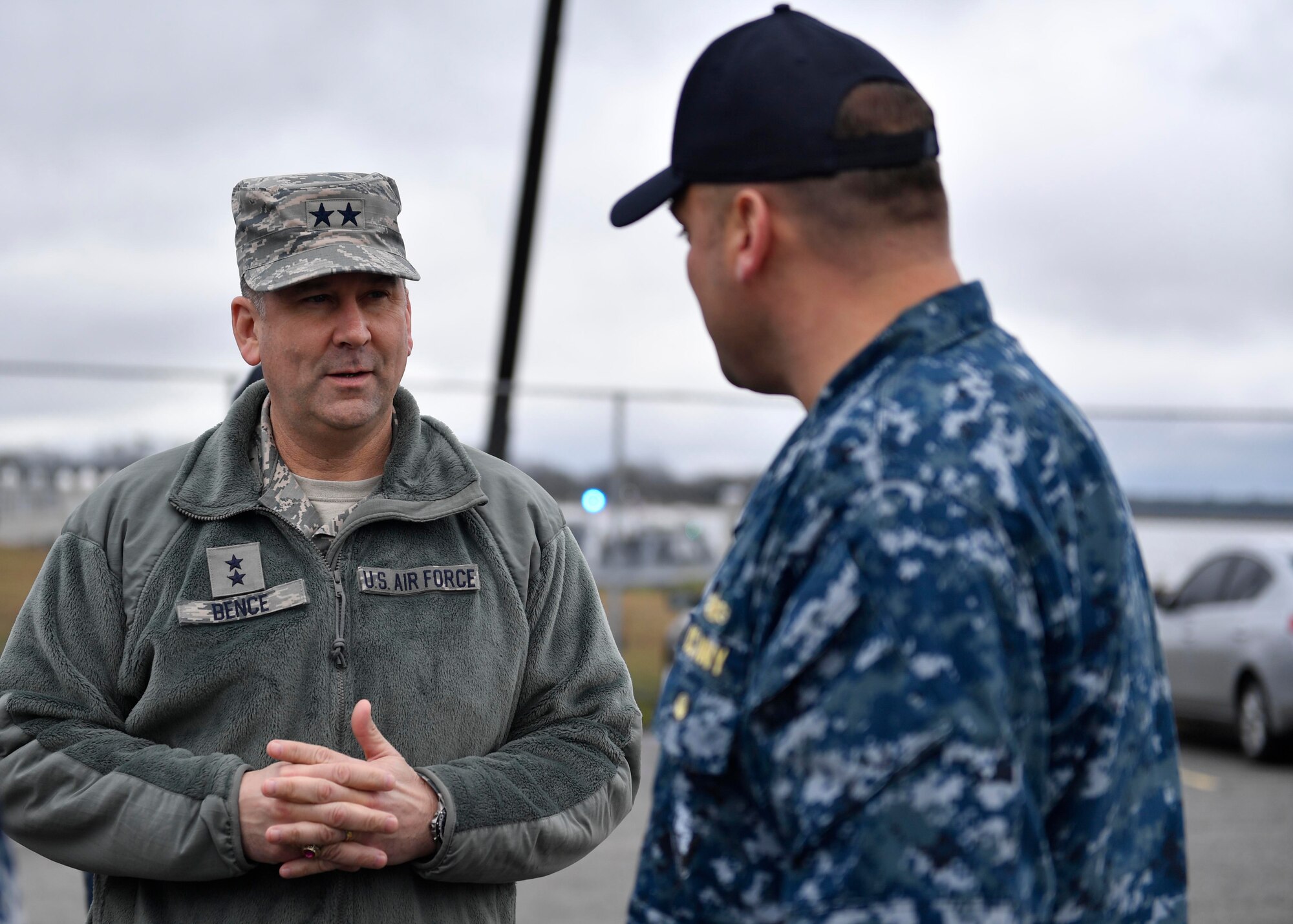Maj. Gen. Christopher J. Bence, U.S. Air Force Expeditionary Center commander, left, learns about port operations from Lt. Charles Gatewood, port operations officer, right, at Pier Charlie on the Joint Base Charleston - Weapons Station, Dec. 14, 2016. While at JB Charleston, Bence  toured Team Charleston's facilities to get a first-hand look at joint operations. 