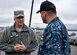 Maj. Gen. Christopher J. Bence, U.S. Air Force Expeditionary Center commander, left, learns about port operations from Lt. Charles Gatewood, port operations officer, right, at Pier Charlie on the Joint Base Charleston - Weapons Station, Dec. 14, 2016. While at JB Charleston, Bence  toured Team Charleston's facilities to get a first-hand look at joint operations. 