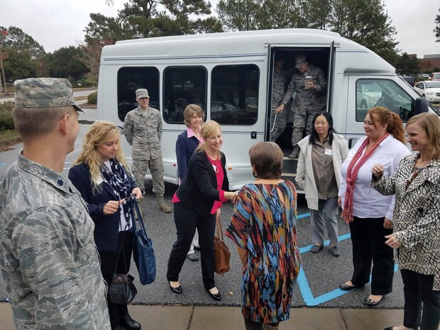 Linda Sturgeon, 628th Force Support Squadron Education Office element chief, center, greets Wendy Bence, second to left, wife of Maj. Gen. Christopher J. Bence, U.S. Air Force Expeditionary Center commander, Lisa Williams, third to left, wife of Chief Master Sgt. Larry Williams, U.S. Air Force Expeditionary Center command chief and Team Charleston key spouses at the Base Education and Training Office here Dec. 14, 2016. Wendy and Lisa toured the Base Education and Training Office to understand the organizations supporting the educational needs of Team Charleston. 