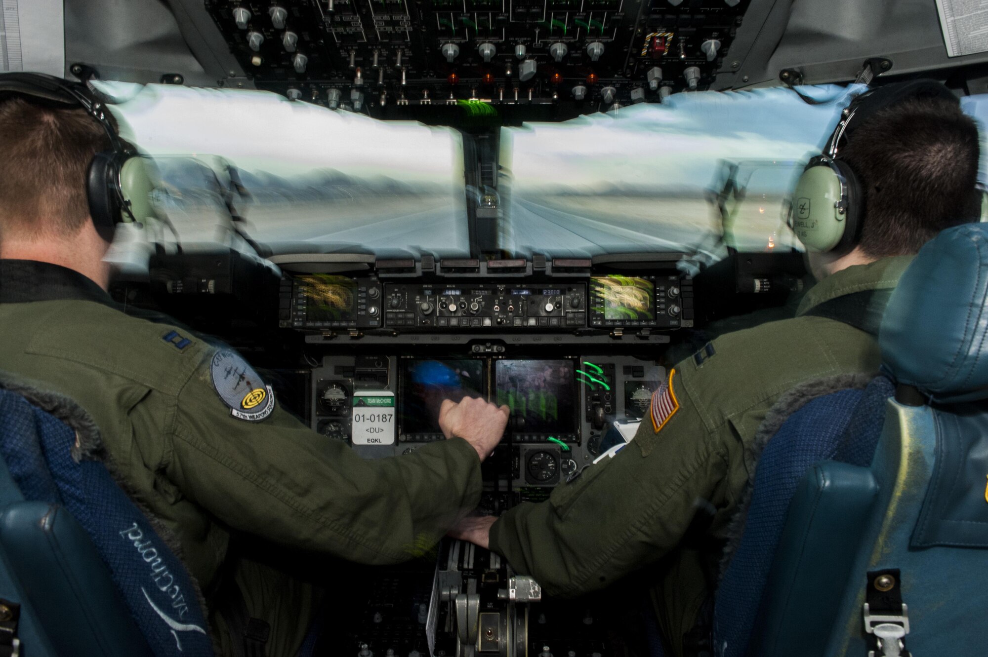 Capt. Mike “Havac” Gilpatrick, a pilot assigned to the 9th Airlift Squadron, Joint Base McGuire-Dix-Lakehurst, N.J., and Capt. Jason “Brick” Sewell, a pilot assigned to the 43rd Operation Support Squadron pilot, Pope Air Force Base, N.C., take-off in a C-17 Globemaster III from Nellis Air Force Base, Nev., Dec. 10, 2016. The C-17 Globemaster III is the newest, most flexible cargo aircraft to enter the airlift force. (U.S. Air Force photo by Airman 1st Class Kevin Tanenbaum)