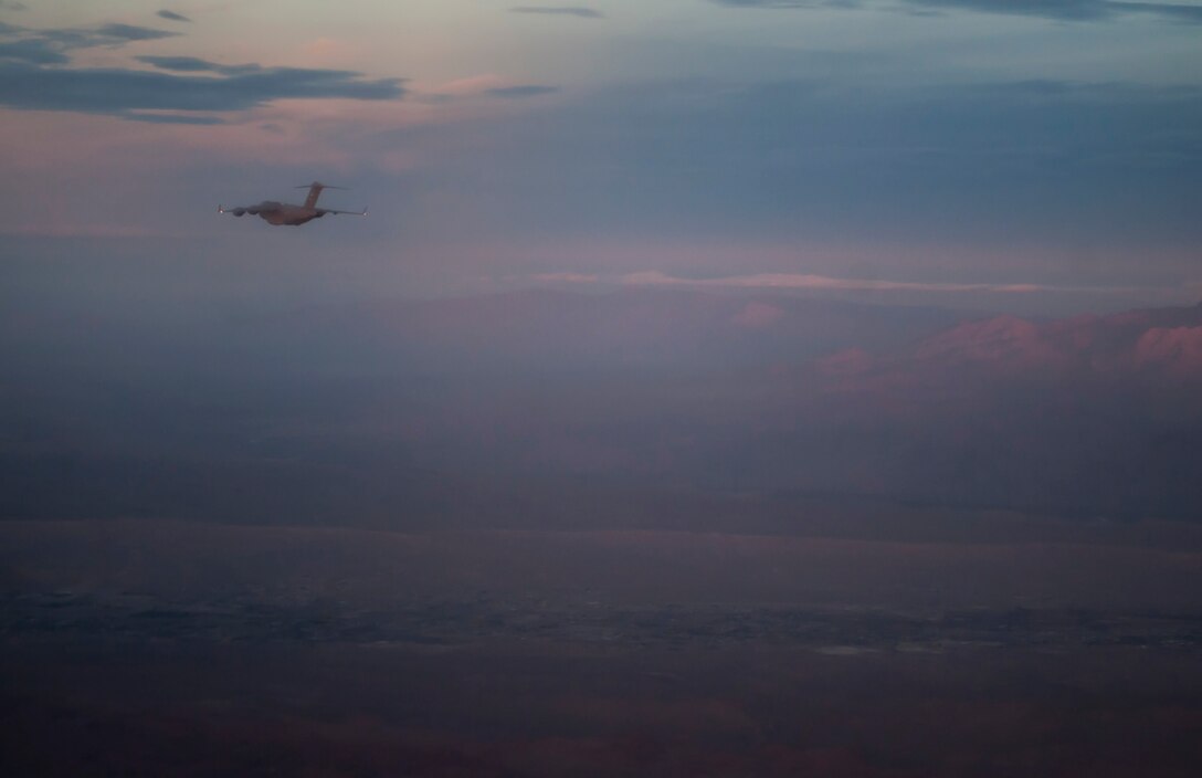 A C-17 Globemaster III flies over the Nevada Test and Training Range during a joint forcible entry exercise, Dec. 10, 2016. Joint-service exercises like JFEX have long been integral to maintaining cohesiveness between the Air Force and the Army in an era where a new conflict can spark at any moment around the world. (U.S. Air Force photo by Airman 1st Class Kevin Tanenbaum)