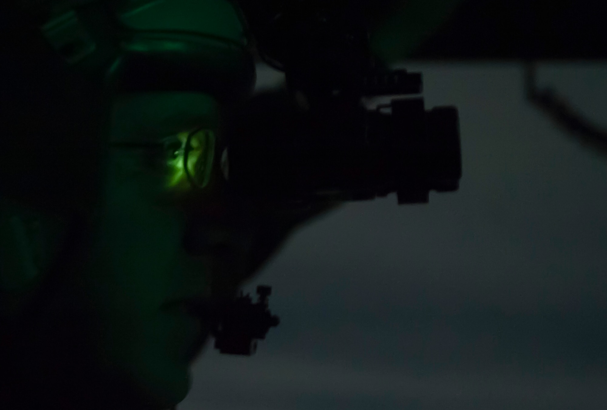Capt. Dan “Filter” Naske, 57th Weapons Squadron pilot, uses night vision goggles to see while flying in a C-17 Globemaster III over the Nevada Test and Training Range on Dec. 10, 2016. The C-17 is operated by Air Mobility Command located at Travis Air Force Base, Calif.; Dover Air Force Base, Del.; Joint Base Lewis-McChord, Wash.; Joint Base Charleston, S.C., and Joint Base McGuire-Dix-Lakehurst, N.J. (U.S. Air Force photo by Airman 1st Class Kevin Tanenbaum)