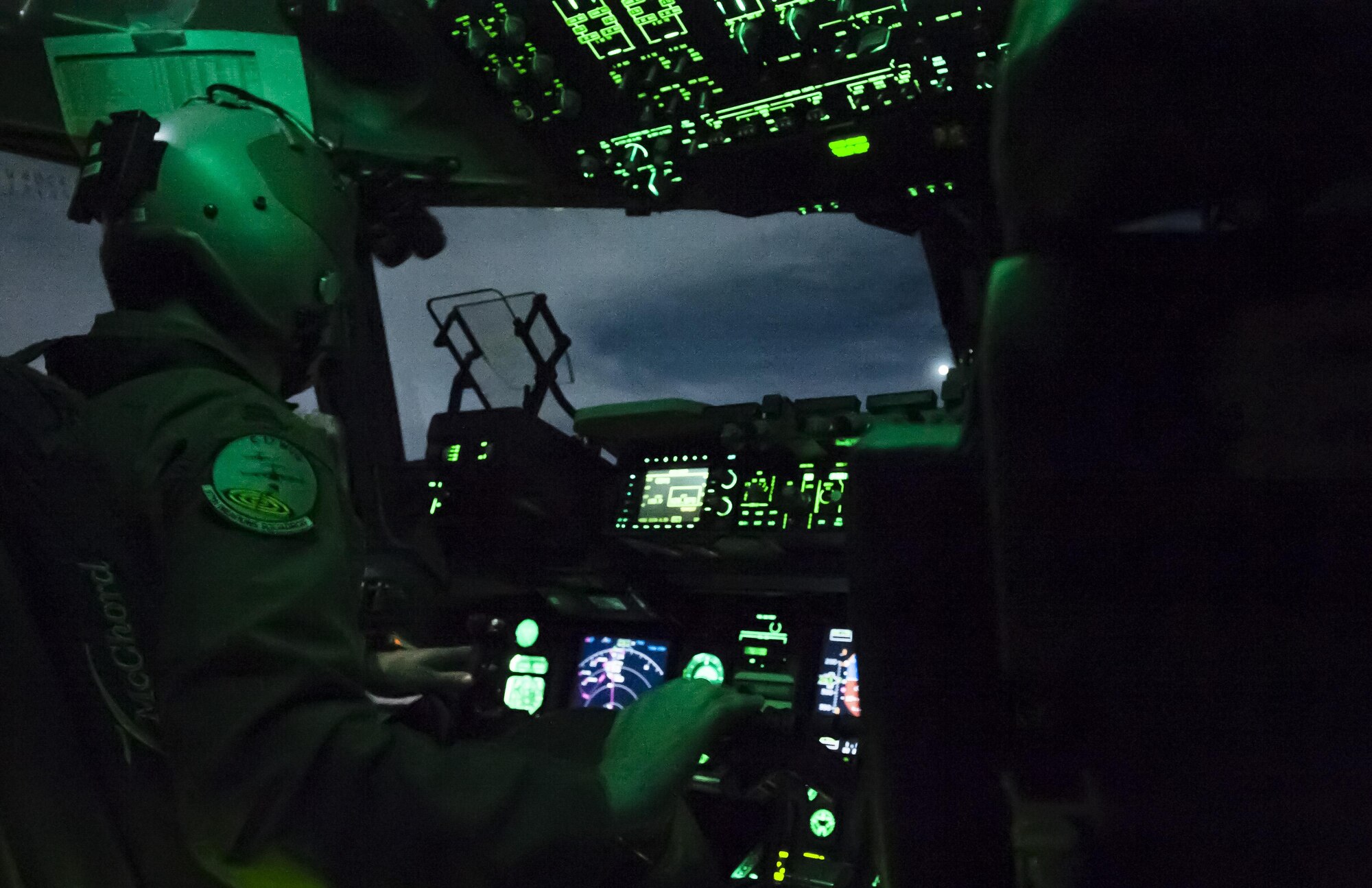 Capt. Mike “Havac” Gilpatrick, a pilot assigned to the 9th Airlift Squadron, flies a C-17 Globemaster III at night during a joint forcible entry exercise over the Nevada Test and Training Range, Dec. 10, 2016. Joint service exercises like the JFEX are integral to maintaining operational cohesiveness between the Air Force and the Army. (U.S. Air Force photo by Airman 1st Class Kevin Tanenbaum)