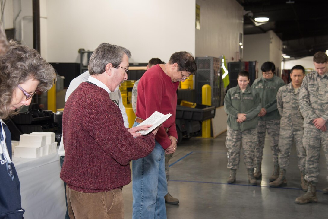 Father Charles Weiss, Christ Church in Dover, says grace before the serving of the food at the 13th annual Feed the Troops lunch Dec. 16, 2016, on Dover Air Force Base, Del. Weiss was one of the many local community leaders who volunteered to prepare and serve food for base personnel. (U.S. Air Force photo by Mauricio Campino)