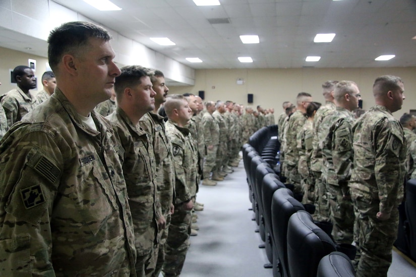 Soldiers assigned to Task Force Granite of the 368th Eng. Bn. stand at attention during the battalion’s first Non-Commissioned Officer Induction Ceremony signifying the passage from enlisted Soldier to the rank of Sergeant within the NCO Corps at Camp Arifjan, Kuwait, November 29, 2016.   (U.S. Army photo by Capt. Maria Mengrone/Released)
