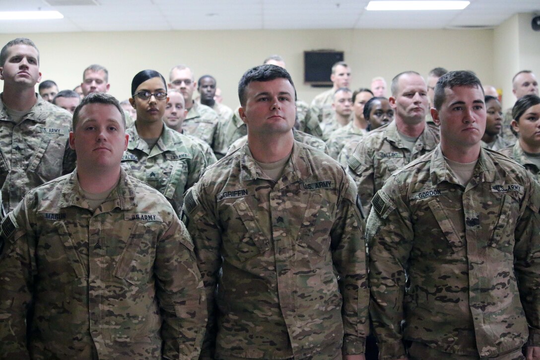 Soldiers assigned to Task Force Granite of the 368th Eng. Bn. stand at attention during the battalion’s first Non-Commissioned Officer Induction Ceremony signifying the passage from enlisted Soldier to the rank of Sergeant within the NCO Corps at Camp Arifjan, Kuwait, November 29, 2016. (U.S. Army photo by Capt. Maria Mengrone/Released)