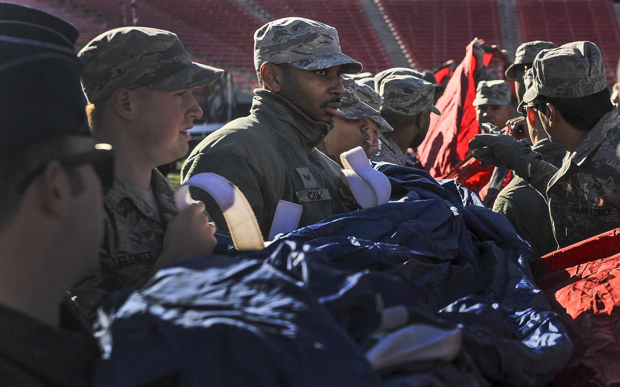 Airmen from Nellis and Creech Air Force Base unfold the American flag at Sam Boyd Stadium before the Las Vegas Bowl, Dec. 17, 2016. Over a 150 Airmen from Nellis and Creech AFB volunteered to hold the flag during the playing of the national anthem before the start of the bowl game. (U.S. Air Force photo by Airman 1st Class Kevin Tanenbaum/Released)