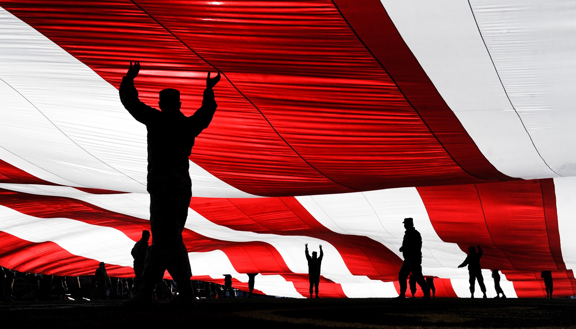 Airmen from Nellis and Creech Air Force Base hold the American flag at Sam Boyd Stadium before the Las Vegas Bowl, Dec. 17, 2016. The 25th Las Vegas Bowl saw Mountain West champion San Diego State rally by scoring 34 unanswered points to defeat Houston, 34-10. (U.S. Air Force photo by Airman 1st Class Kevin Tanenbaum/Released)