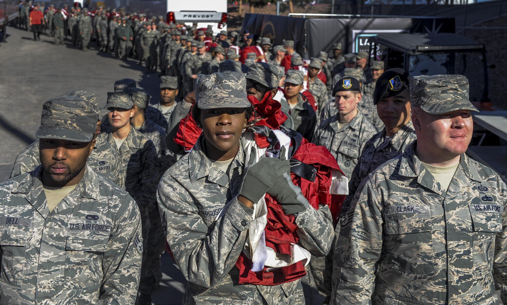 Airmen from Nellis and Creech Air Force Bases carry a large American flag before entering Sam Boyd Stadium during the Las Vegas Bowl, Dec. 17, 2016. The Airmen unveiled the flag before the game as the National Anthem was sung. (U.S. Air Force photo by Airman 1st Class Kevin Tanenbaum/Released)