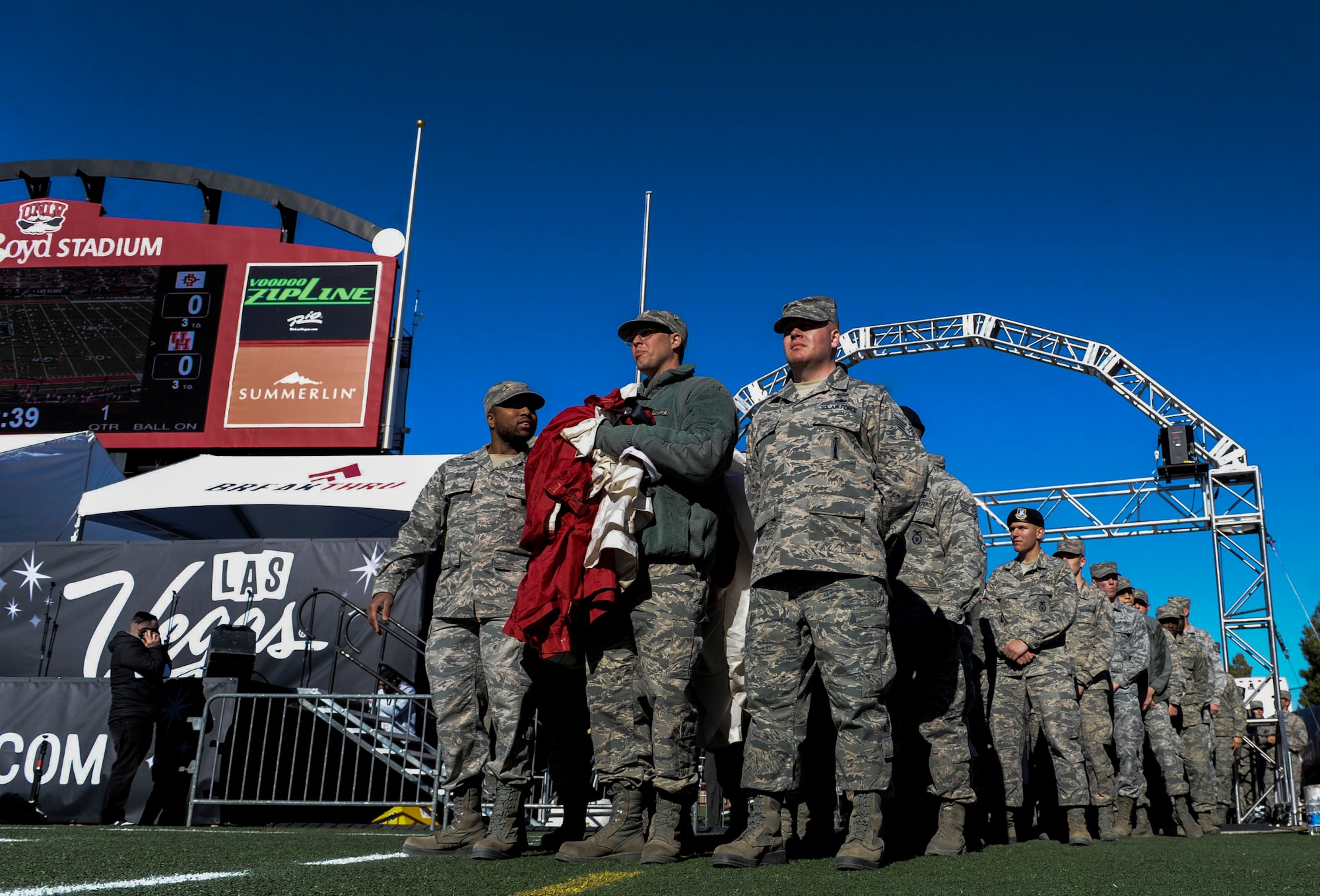 Airmen from Nellis and Creech Air Force Bases wait to step onto the field at Sam Boyd Stadium and unveil a large American flag during the Las Vegas Bowl, Dec. 17, 2016. This year’s game marked the 25th Anniversary of the city of Las Vegas hosting the bowl game. (U.S. Air Force photo by Airman 1st Class Kevin Tanenbaum/Released)