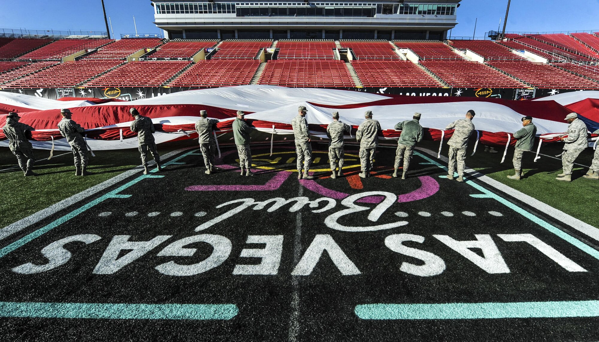 Airmen from Nellis and Creech Air Force Bases spread out the American flag at Sam Boyd Stadium before the Las Vegas Bowl, Dec. 17, 2016. Approximately 150 Airmen volunteered to hold the flag for the pre-game ceremony. (U.S. Air Force photo by Airman 1st Class Kevin Tanenbaum/Released)