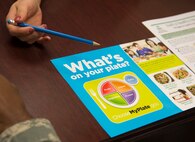 Sandra Stuart, 23d Medical Group health promotion dietitian, gives an Airman resources to help him control his diet, Dec. 19, 2016, at Moody Air Force Base, Ga. Stuart’s services are available at no cost to all active duty, dependents, and retirees. (U.S. Air Force photo by 2d Lt. Kaitlin Toner)