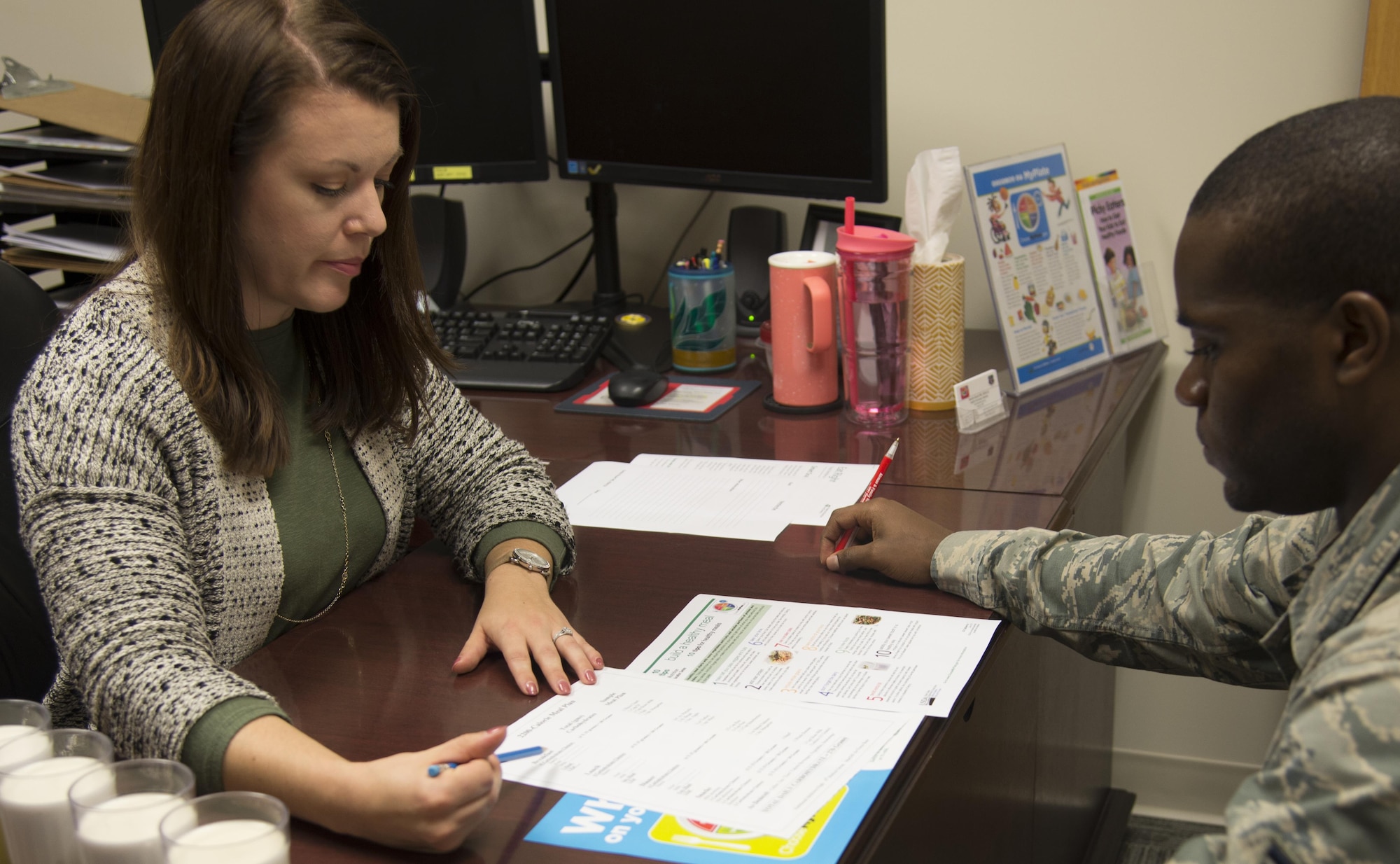 Sandra Stuart, 23d Medical Group health promotion dietitian, goes through an example meal plan with an Airman, Dec. 19, 2016, at Moody Air Force Base, Ga. Stuart provides individual sessions to personalize meal plans for individual goals. (U.S. Air Force photo by 2d Lt. Kaitlin Toner)