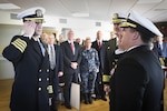 Capt. Scott Kraft salutes NSWC Commander Rear Adm. Tom Druggan after taking the helm of NSWC IHEODTD from Capt. Vincent Martinez at Indian Head, Dec. 15. 