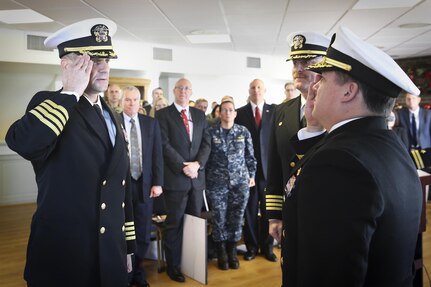 Capt. Scott Kraft salutes NSWC Commander Rear Adm. Tom Druggan after taking the helm of NSWC IHEODTD from Capt. Vincent Martinez at Indian Head, Dec. 15. 