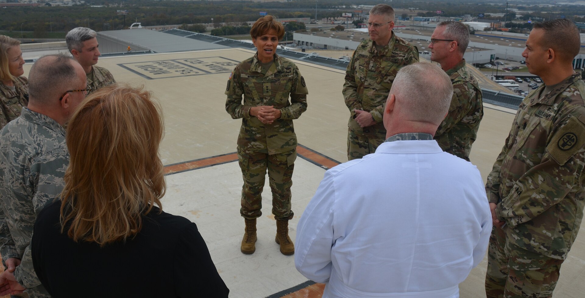 Lt. Gen. Nadja West, U.S. Army Surgeon General, talks with Army and Air Force doctors about Brooke Army Medical Center’s trauma mission at Joint Base San Antonio-Fort Sam Houston Dec. 14 as they toured the only rooftop helipad in the Department of Defense. 