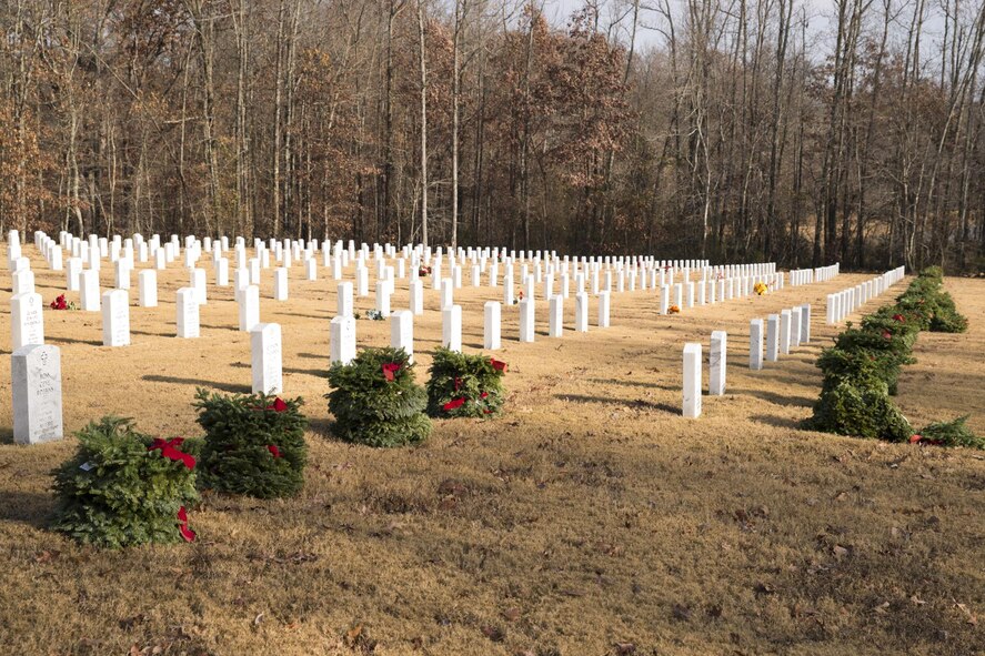 Holiday wreaths await distribution in Section A, of the Arkansas State Veterans Cemetery in North Little Rock Ark., Dec. 17, 2016. Hundreds of volunteers placed more than 5,000 wreaths at veterans’ headstones as part of the Wreaths Across America Program, which was started quietly in 1992, by Worchester Wreath Company, but gained National attention in 2005. (U.S. Air Force photo by Master Sgt. Jeff Walston/ Released)