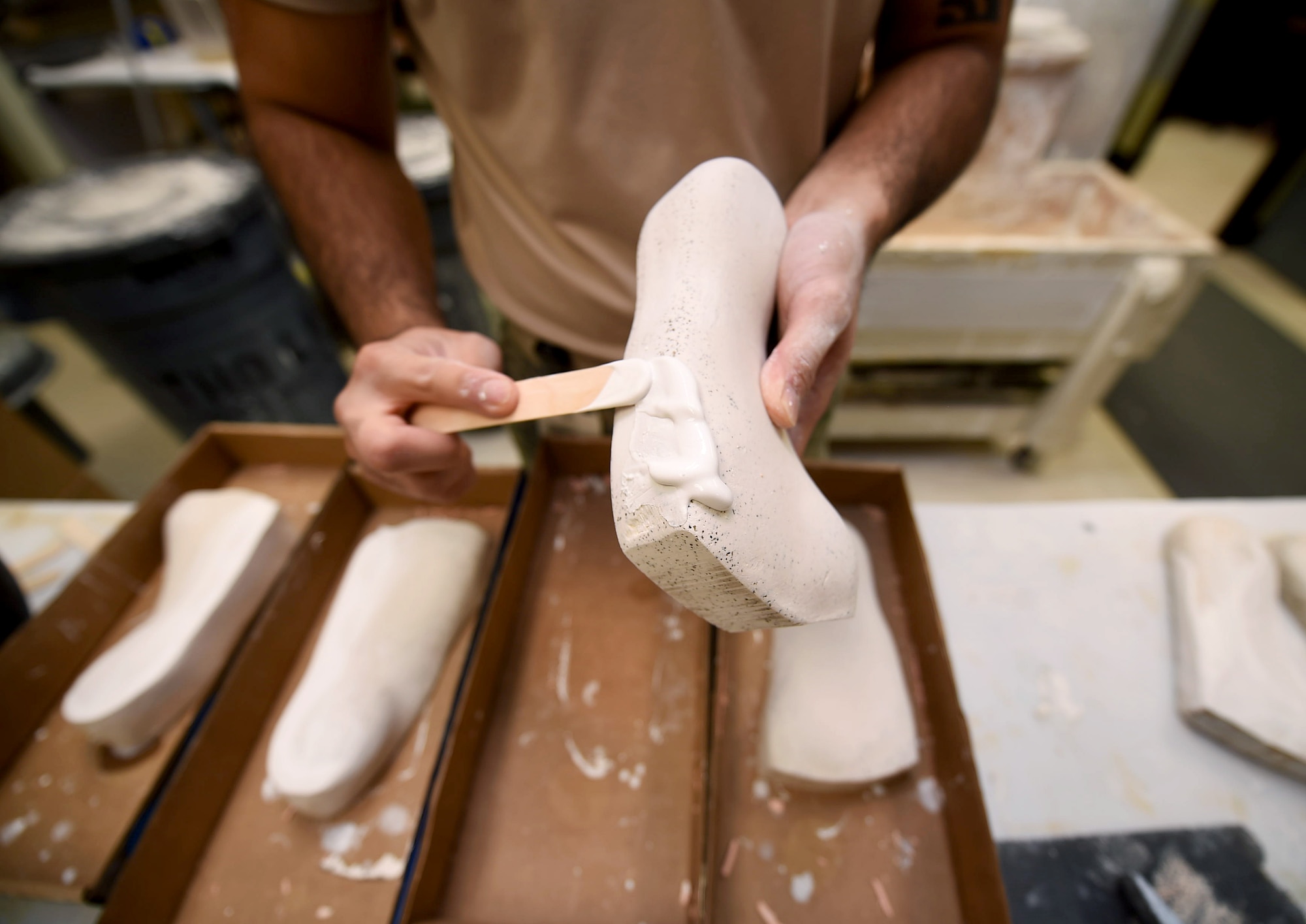 Staff Sgt. Kenneth Rivera, a student in the orthotics program, works on a foot mold at the Wilford Hall Ambulatory Surgical Center, Joint Base San Antonio-Lackland, Texas, Aug. 24, 2016.(U.S. Air Force photo/Staff Sgt. Jerilyn Quintanilla)