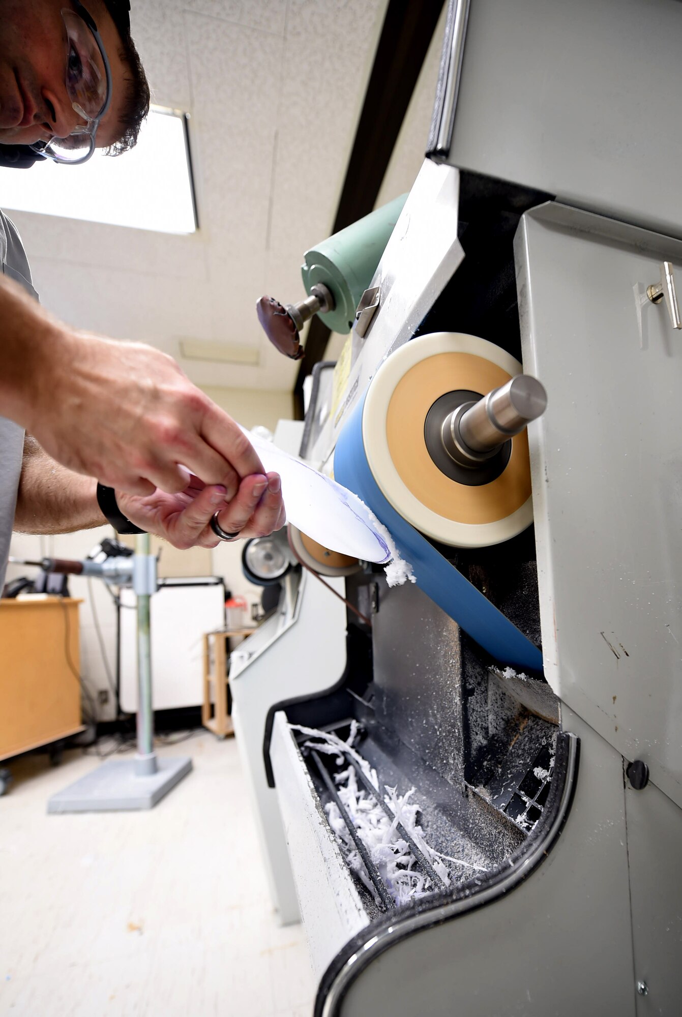 Staff Sgt. Devin Rudd, a student in the orthotics program, shaves the excess plastic off a foot orthoses at the Wilford Hall Ambulatory Surgical Center, Joint Base San Antonio-Lackland, Texas, Aug. 24, 2016.(U.S. Air Force photo/Staff Sgt. Jerilyn Quintanilla)