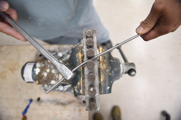 Staff Sgt. Kenneth Rivera, a student in the orthotics program, bends a piece of metal to use for an orthoses at the Wilford Hall Ambulatory Surgical Center, Joint Base San Antonio-Lackland, Texas, Oct. 19, 2016. (U.S. Air Force photo/Staff Sgt. Jerilyn Quintanilla)