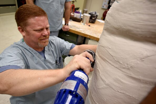 Lawrence New, a 59th Medical Wing orthotist and orthotics instructor, cuts through a plaster mold at the Wilford Hall Ambulatory Surgical Center, Joint Base San Antonio-Lackland, Texas, Aug. 24, 2016. (U.S. Air Force photo/Staff Sgt. Jerilyn Quintanilla)