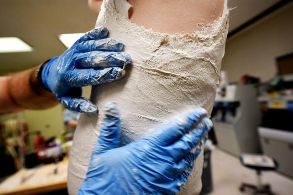Staff Sgt. Devin Rudd, a student in the orthotics program, applies plaster to a mock patient to make a body jacket orthoses at the Wilford Hall Ambulatory Surgical Center, Joint Base San Antonio-Lackland, Texas, Aug. 24, 2016. As part of his training to become an orthotics technician, Rudd must learn how the process of fabricating various types of orthoses. (U.S. Air Force photo/Staff Sgt. Jerilyn Quintanilla)