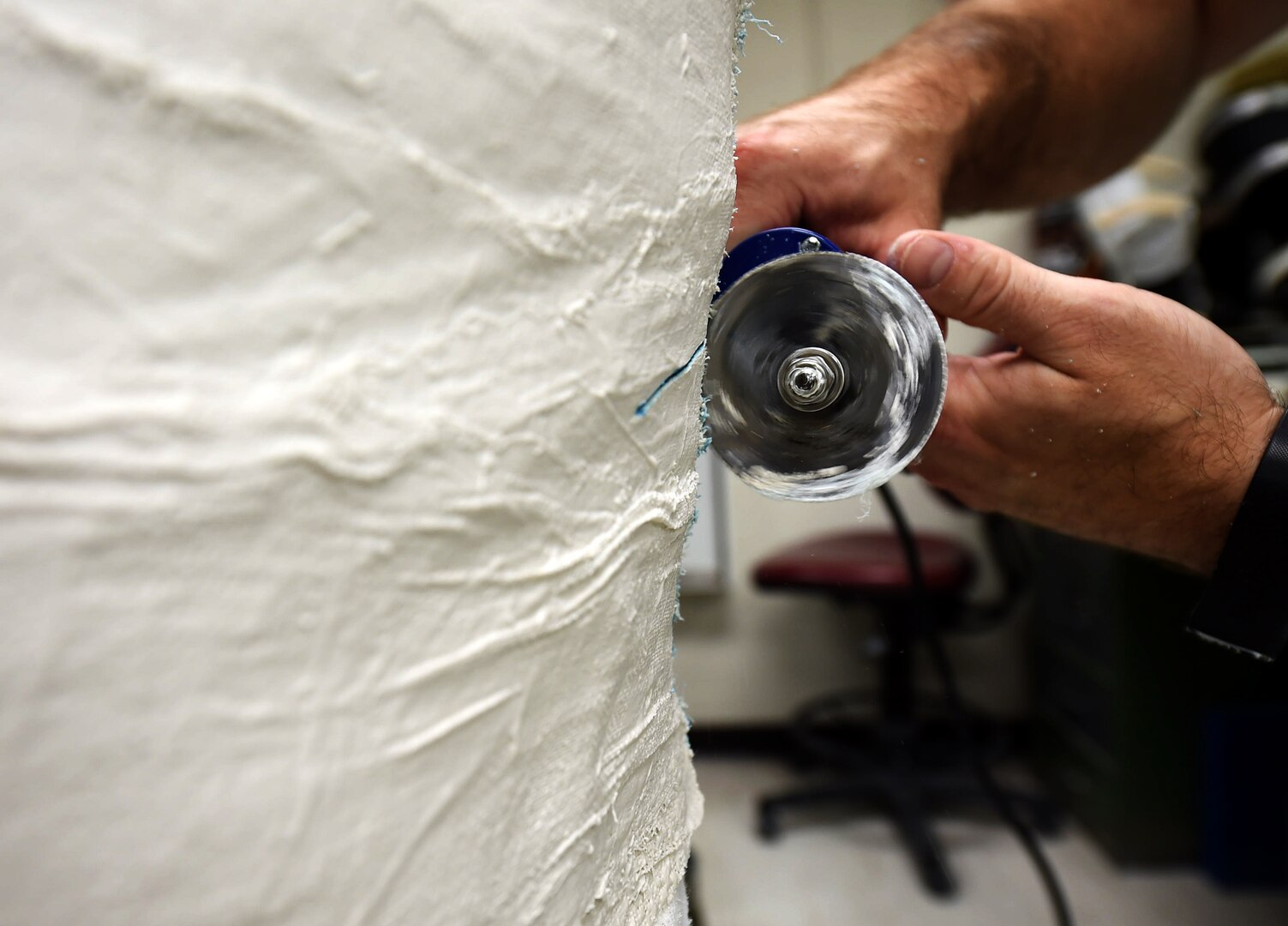 Staff Sgt. Devin Rudd, a student in the orthotics program, cuts through a plaster mold of a body jacket orthoses at the Wilford Hall Ambulatory Surgical Center, Joint Base San Antonio-Lackland, Texas, Aug. 24, 2016. As part of his training to become an orthotics technician, Rudd must learn how the process of fabricating various types of orthoses. (U.S. Air Force photo/Staff Sgt. Jerilyn Quintanilla)