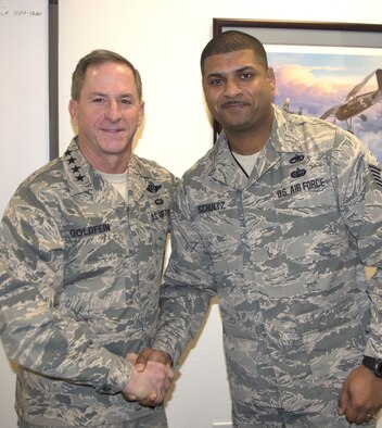 Air Force Chief of Staff Gen. David L. Goldfein presents his recognition coin to Tech. Sgt. Dan Schultz, an airborne mission systems manager, 625th Air Support Squadron, during his visit to San Antonio, Texas, Dec. 19.