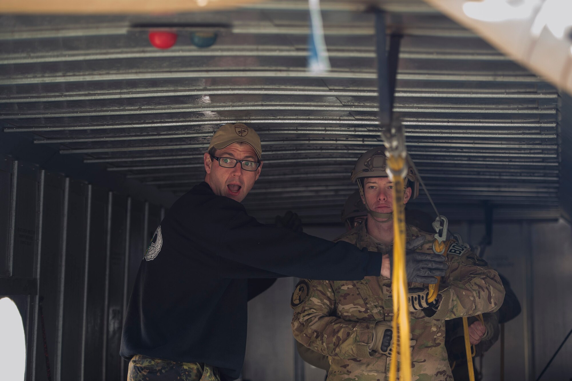 U.S. Air Force Senior Airman Kyle Lock, 824th Base Defense Squadron fireteam member, waits for the command to jump from Master Sgt. Martin Bender, German Army Airborne Brigade 1 primary jumpmaster instructor, during the 19th Annual Randy Oler Memorial Operation Toy Drop, Dec. 15, 2016, at Mackall Army Air Field, N.C. During Operation Toy Drop, the 820th BDG trained alongside fellow Airmen under the 93d Air Ground Operations Wing, U.S. Army airborne specialists and foreign jumpmasters on seven different aircraft to master static line and military free fall jumps. (U.S. Air Force photo by Airman 1st Class Greg Nash)   