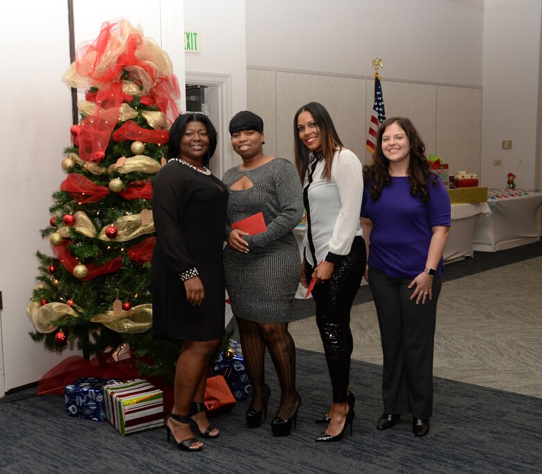 Active-duty Sailors and civilian personnel at Naval Branch Health Clinic-Albany, aboard Marine Corps Logistics Base Albany, kick off the holiday season at the Hilton Garden Inn, Albany, Ga., Dec. 15. Clinic personnel (left to right) Shebreaka Clyde, clinical nurse; Clarissa Bryant, executive assistant, and Petty Officer 2nd Class Chloee Ward partnered with Lt. Amy Starling, senior nurse executive/interim officer-in-charge, NBHC-Albany, to coordinate the annual event.
