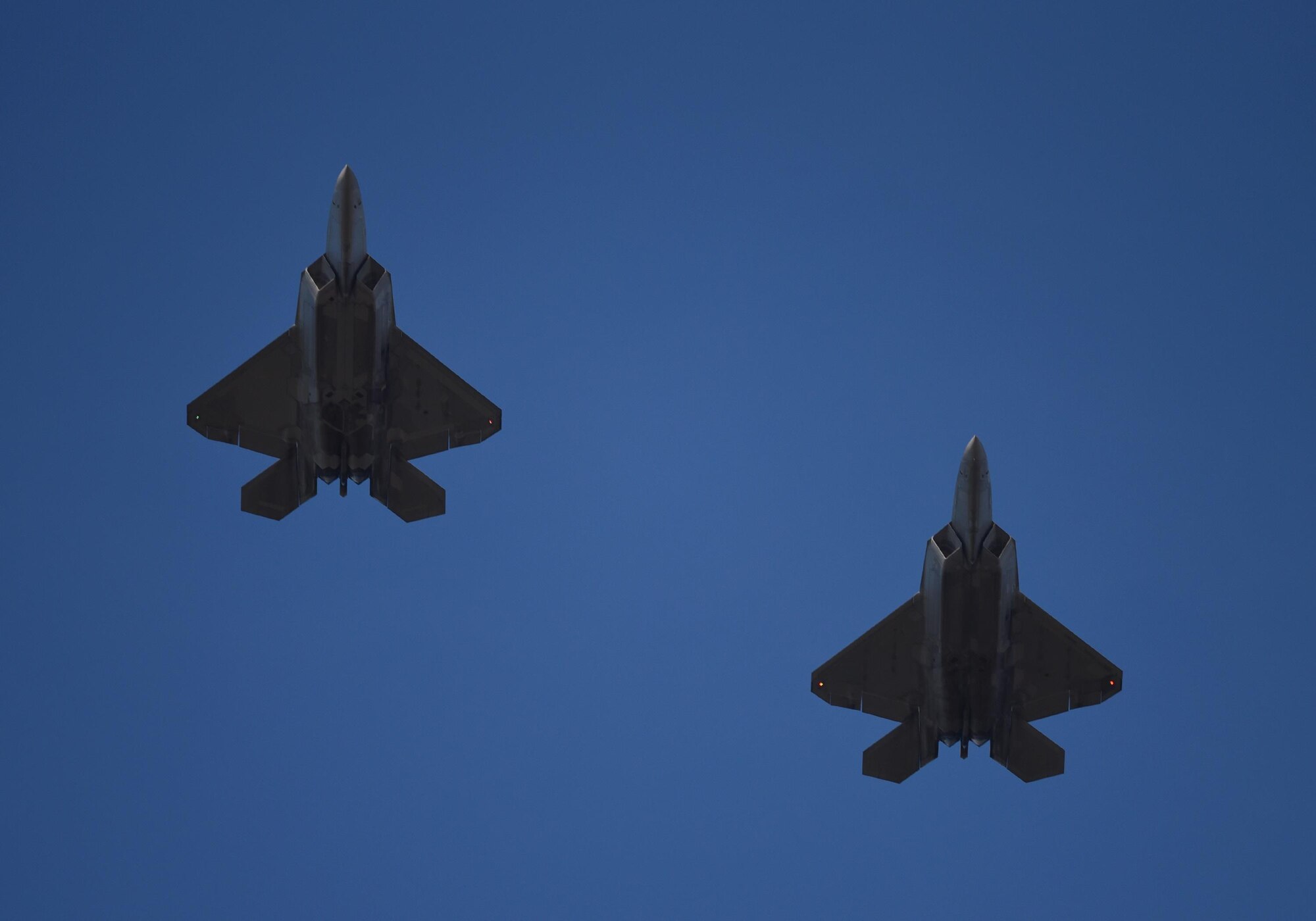 Two U.S. Air Force F-22 Raptors from Tyndall Air Force Base, Fla., fly in formation during Checkered Flag 17-1, Dec. 16, 2016. The integration training pilots receive during exercises like Checkered Flag ensure teams of different capabilities can seamlessly integrate and work together in a real-world combat situation utilizing fifth- and fourth-generation air assets. (U.S. Air Force photo by Staff Sgt. Alex Fox Echols III/Released)