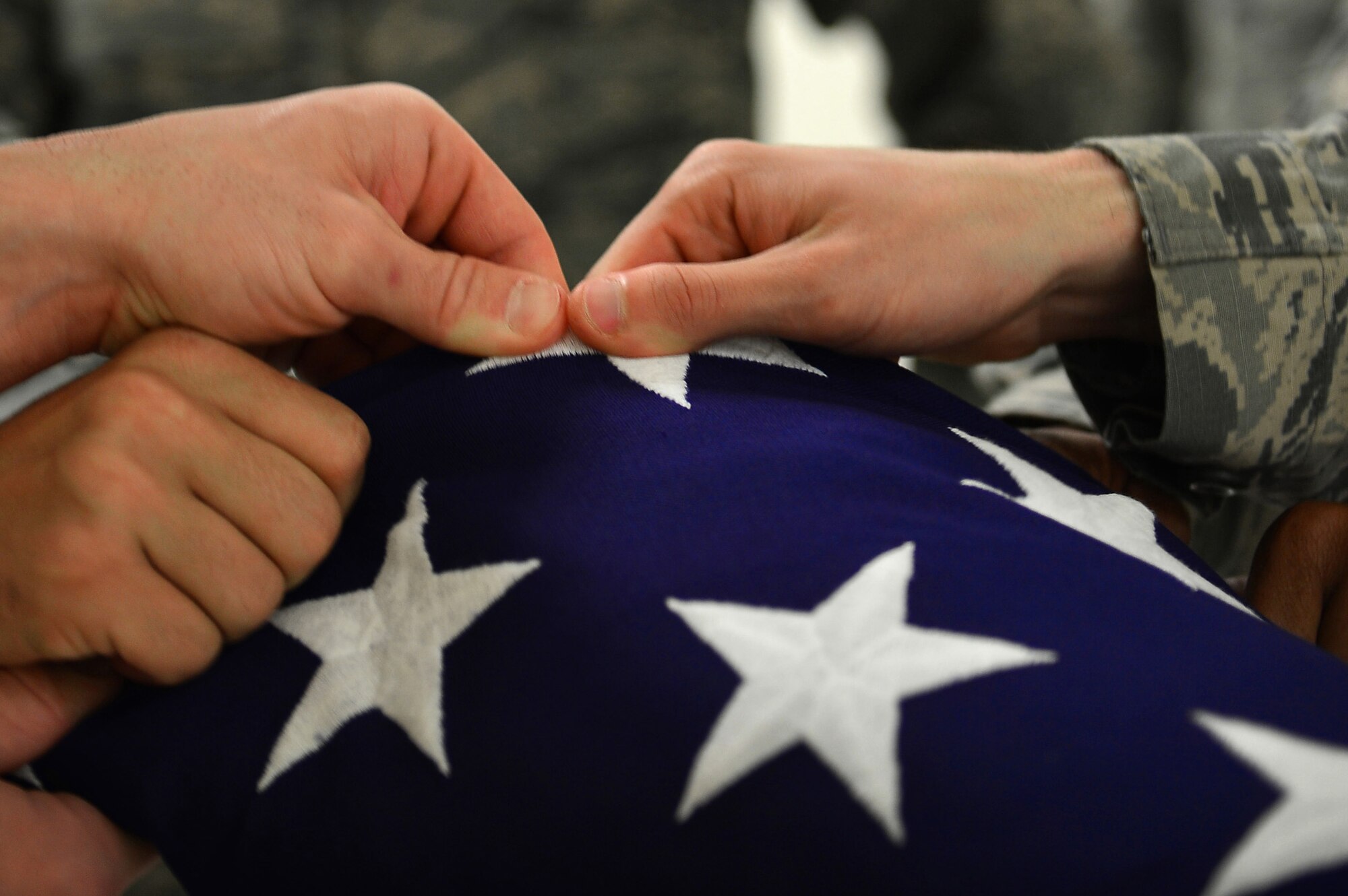 U.S. Airmen assigned to the 20th Force Support Squadron Honor Guard complete folding a flag at Shaw Air Force Base, S.C., Dec. 14, 2016. Honor guardsmen train daily to expertly execute numerous details including change of command ceremonies, retirements and funerals. (U.S. Air Force photo by Airman 1st Class Christopher Maldonado)