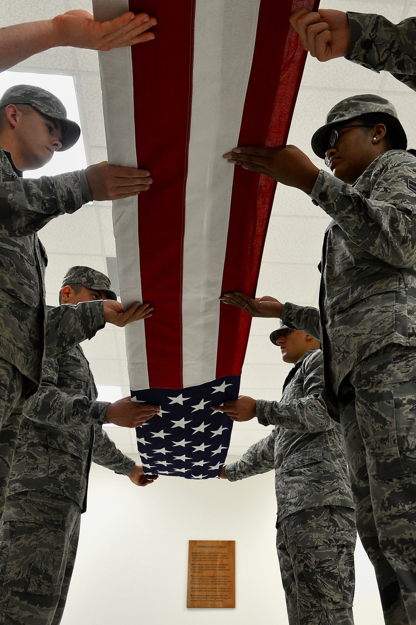 U.S. Airmen assigned to the 20th Force Support Squadron Honor Guard prepare to fold a U.S. flag at Shaw Air Force Base, S.C., Dec. 14, 2016. The honor guardsmen practiced flag folding procedures for a six-man funeral detail, with repetitions until proper execution was achieved. (U.S. Air Force photo by Airman 1st Class Christopher Maldonado)