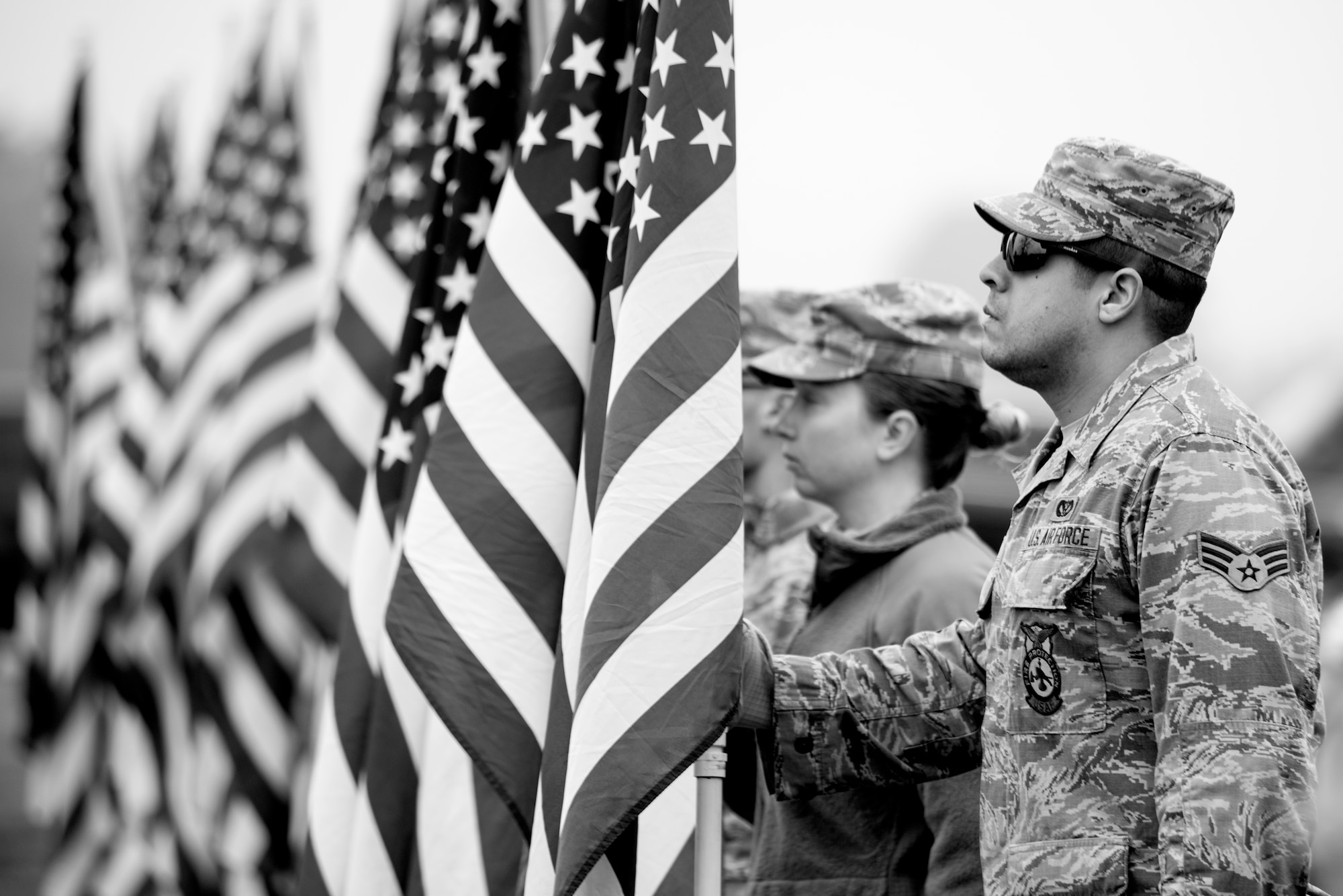 Senior Airman Ethan Salgado, 4th Civil Engineer Squadron fire fighter, holds an American flag during a Wreaths Across America ceremony, Dec. 17, 2016, at Evergreen Memorial Cemetery in Princeton, North Carolina. More than 50 volunteers from the base attended the event to honor the fallen service members. (U.S. Air Force photo by Airman Shawna L. Keyes)