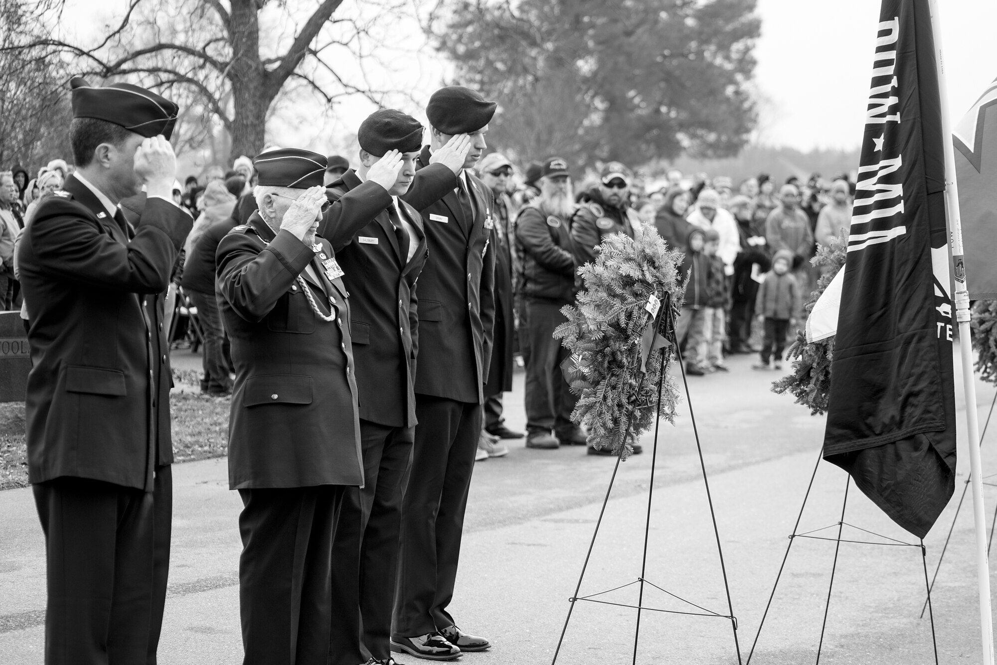 Airmen salute the Prisoner of War and Missing in Action flag during the Wreaths Across America ceremony, Dec. 17, 2016, at Evergreen Memorial Cemetery in Princeton, North Carolina. More than 50 Airmen from Seymour Johnson Air Force Base, North Carolina volunteered at the ceremony. (U.S. Air Force photo by Airman Shawna L. Keyes)