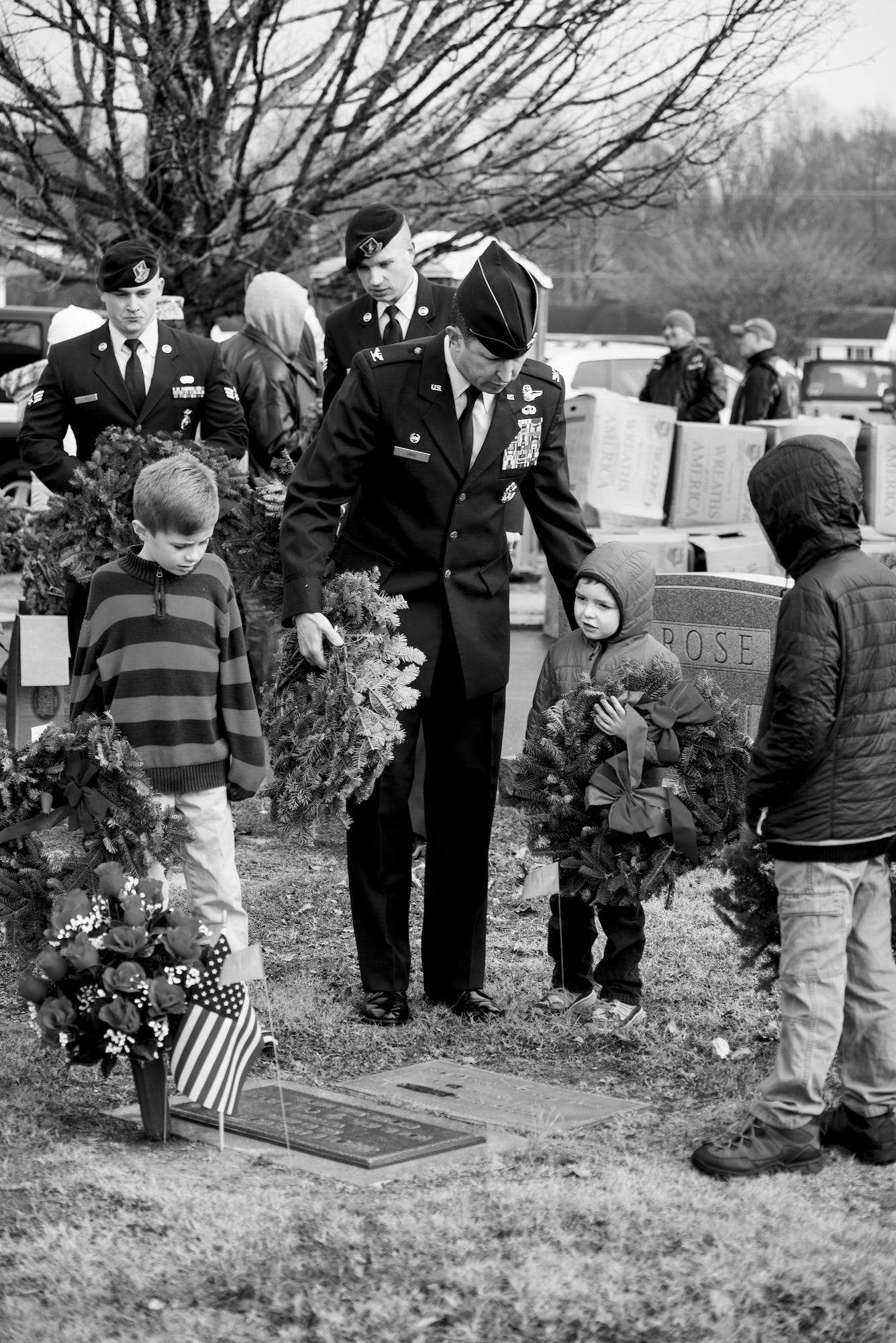 Col. Christopher Sage (center), 4th Fighter Wing commander, lays wreaths on a gravesite with his children during a Wreaths Across America ceremony, Dec. 17, 2016, at Evergreen Memorial Cemetery in Princeton, North Carolina. Wreaths Across America began in Maine 25 years ago and more than 1,200 locations participate worldwide today. (U.S. Air Force photo by Airman Shawna L. Keyes)