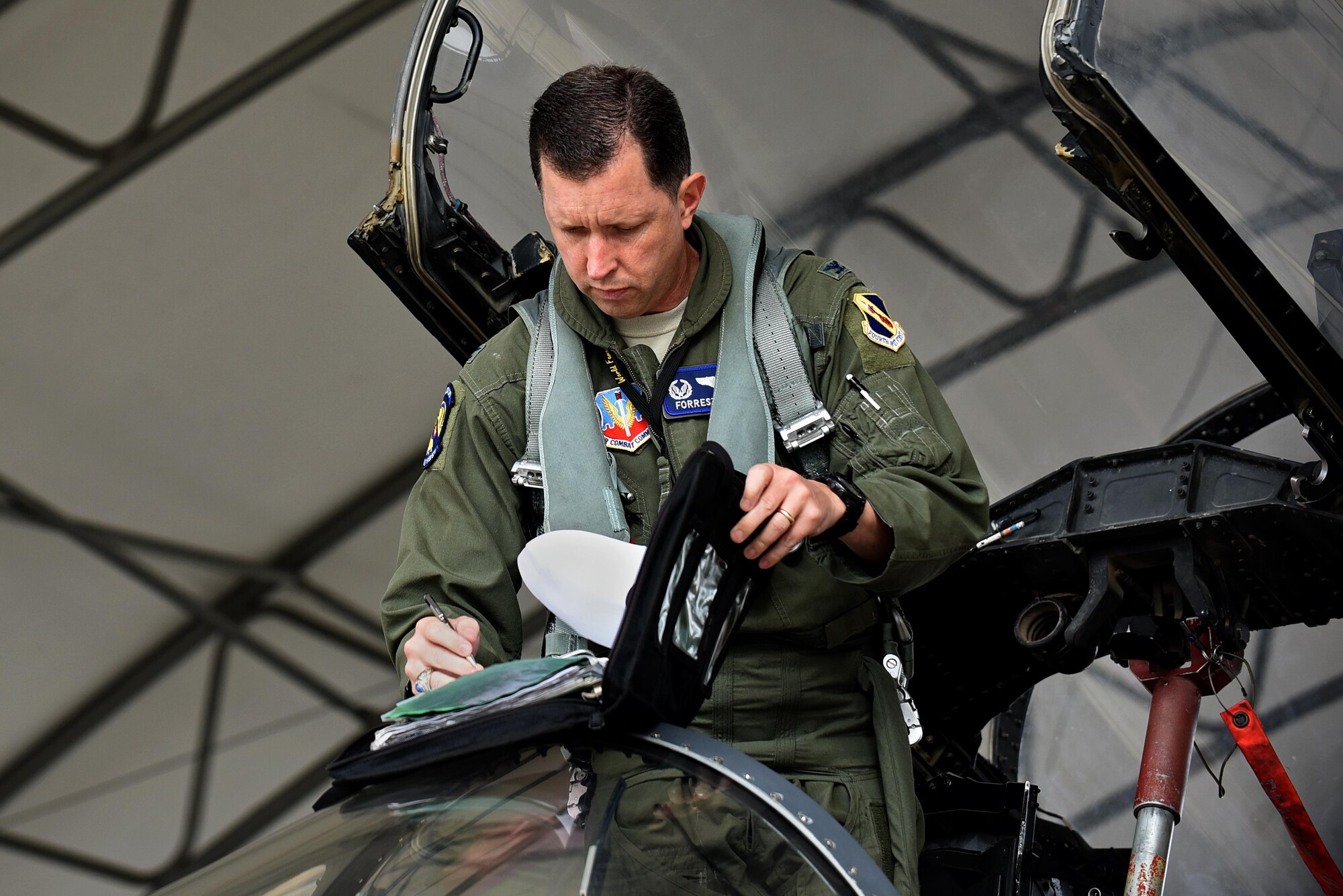 Col. Christopher Sage, 4th Fighter Wing commander, signs aircraft maintenance forms prior to take-off, Nov. 30, 2016, at Seymour Johnson Air Force Base, North Carolina. The maintenance forms indicate who previously repaired the aircraft and is signed off by the pilot. (U.S. Air Force photo by Airman 1st Class Kenneth Boyton)