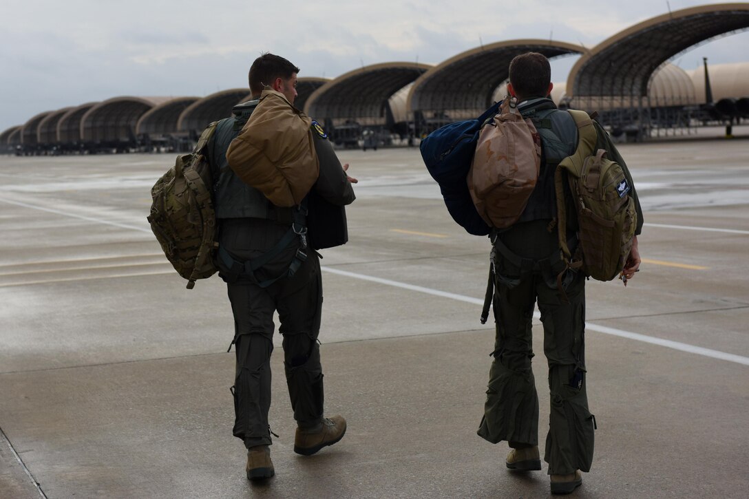 Col. Christopher Sage (right), 4th Fighter Wing commander, and Maj. Brian Privette (left), 4th Fighter Wing executive officer, walk to their aircraft, Nov. 30, 2016, at Seymour Johnson Air Force Base, North Carolina. Seymour Johnson has more than 90 F-15E Strike Eagle aircraft assigned to two operational and two training fighter squadrons that go to a programmed depot maintenance at Robins Air Force Base, Georgia, approximately every three years. (U.S. Air Force photo by Airman Miranda A. Loera)