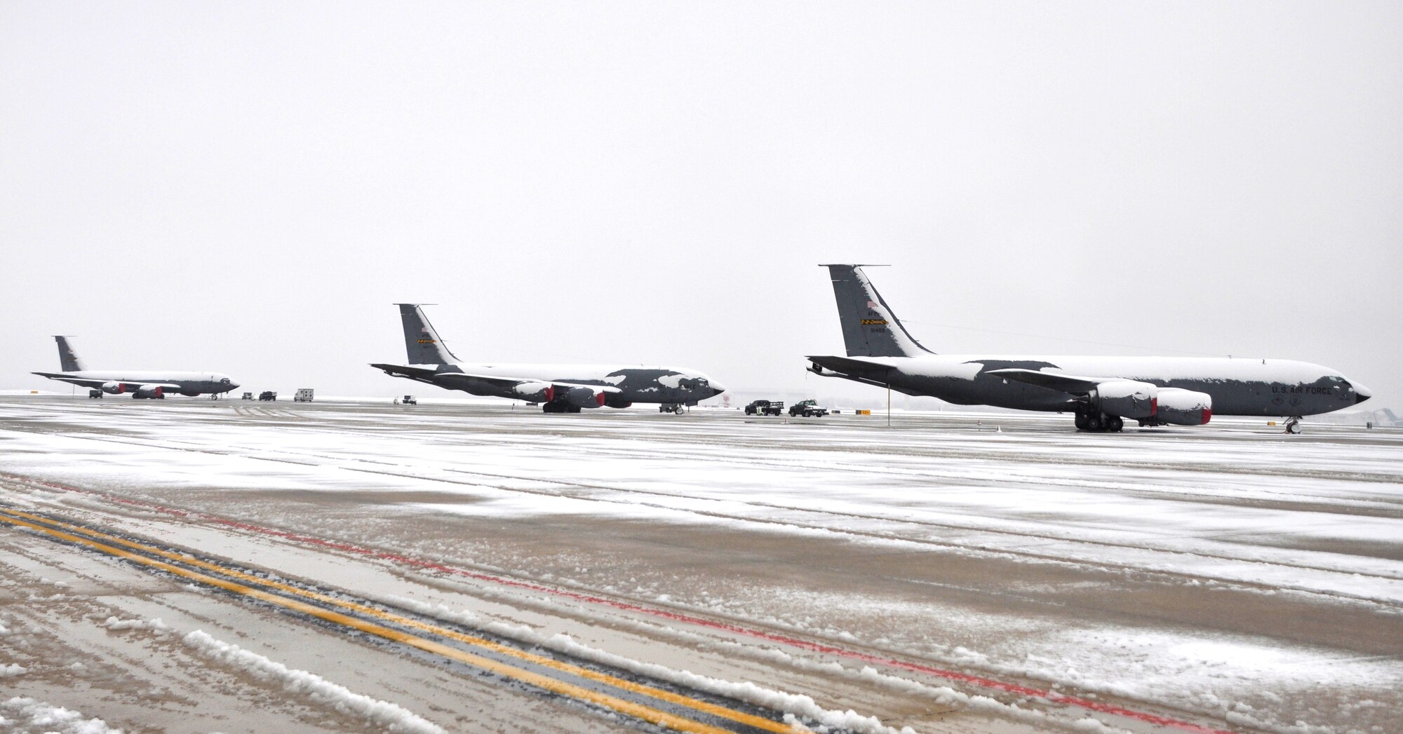 Three KC-135 Stratotankers from the 459th Air Refueling Wing sit on a snow-covered flightline on Joint Base Andrews, Md., after a snowstorm, March 25, 2012. The spring snowstorm was forecasted to bring up to five inches of snow to the local area.(U.S. Air Force photo/ Staff Sgt. Katie Spencer) 
