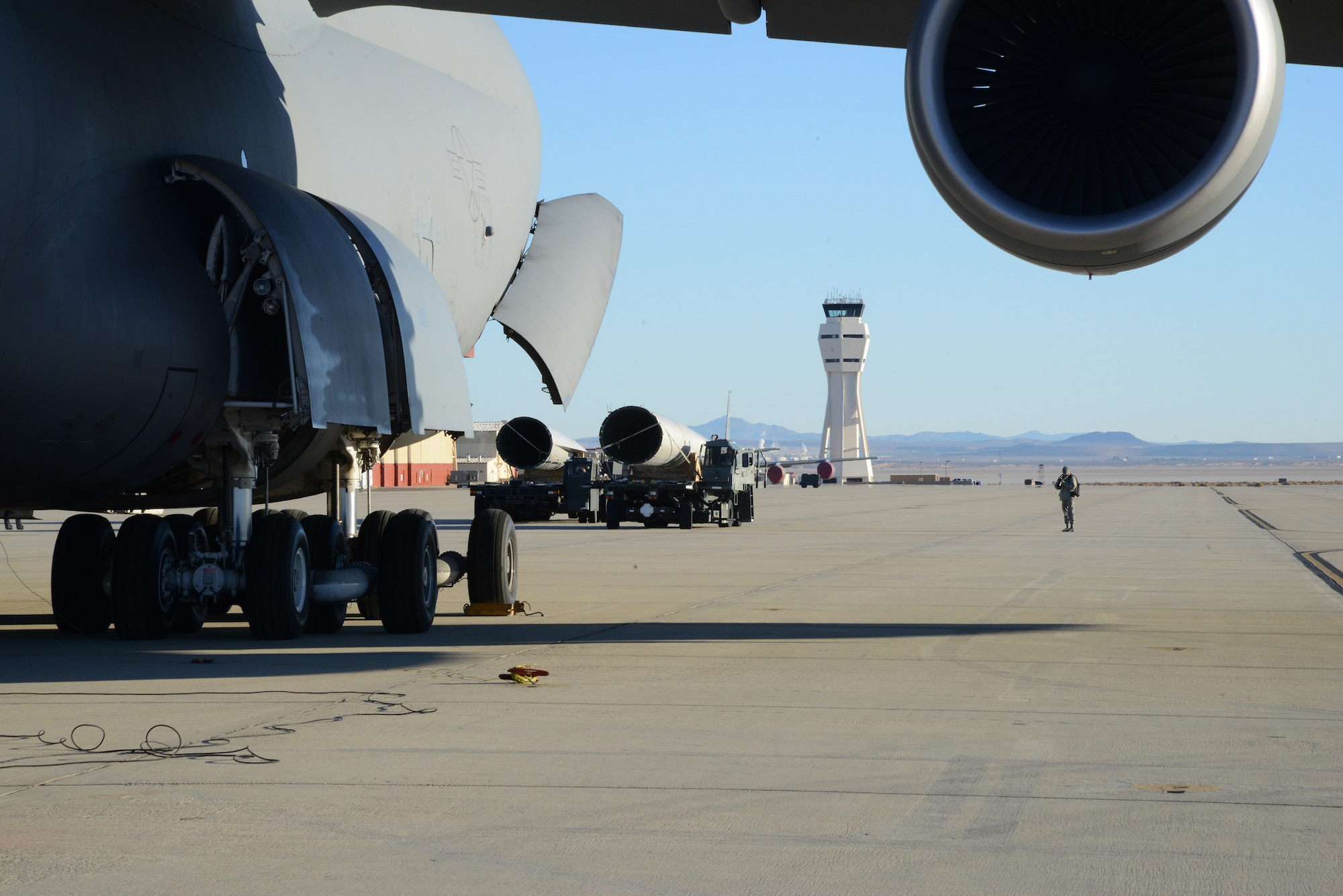 The twin tail sections from a disassembled C-119B “Flying Boxcar” are positioned for loading onto A C-5 Galaxy from Dover Air Force Base, Delaware, on the flightline of Edwards Air Force Base, California, Dec. 19. The C-5 was loaded with the majority of the disassembled aircraft for transportation to the Air Mobility Command Museum at Dover AFB. This airplane, tail number 48-0352, was one of several that played a direct role in the Battle of Chosin Reservoir in the Korean War in 1950.  It will eventually be restored to its Korean War era configuration and displayed at the AMC Museum.