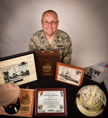 U.S. Air Force Capt. Norman Jones, 628th Air Base Wing chaplain, poses with memorabilia from his career Dec. 14, 2016, at Joint Base Charleston, South Carolina. Jones has given more than two decades of military service to his country while serving in the Navy, Army and then the Air Force.